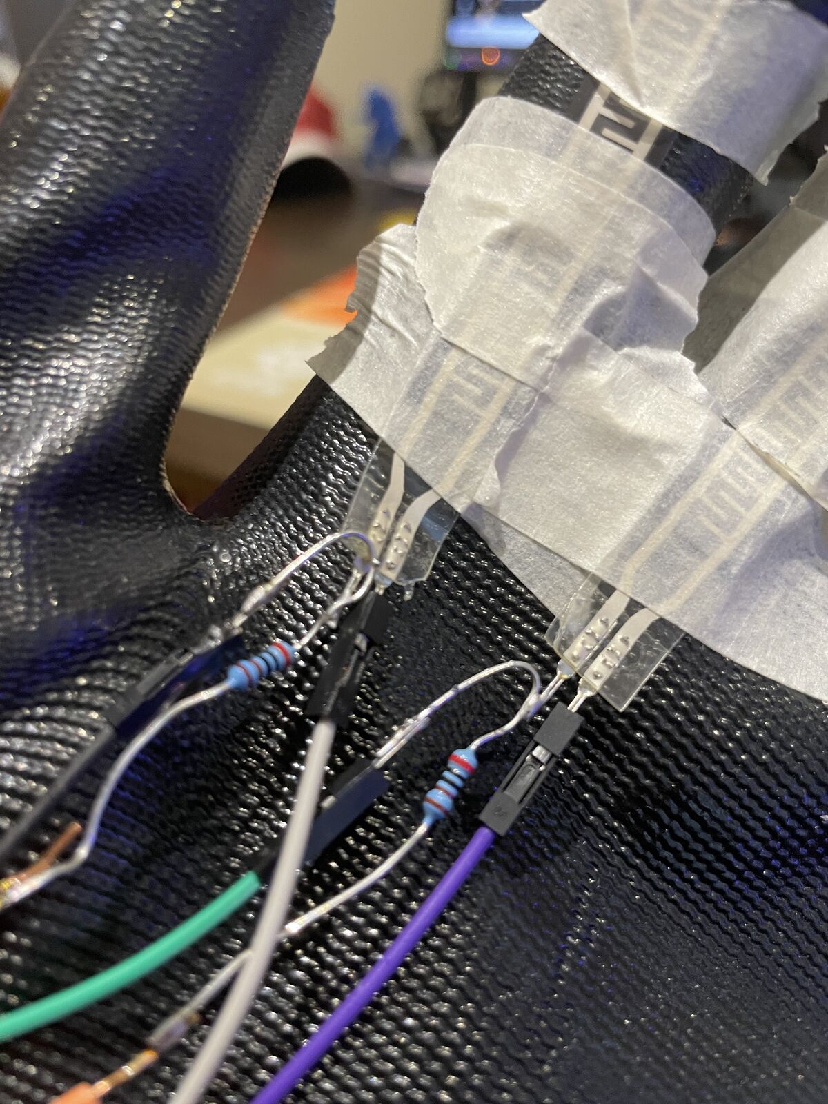 Close-up of the flex sensors and voltage divider resistors wired onto the glove fingers